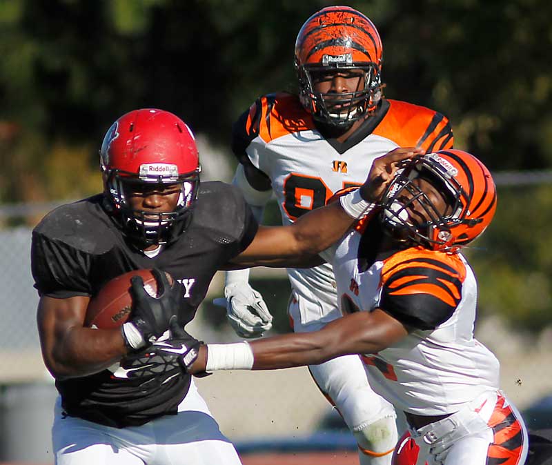 Running back Nick Birdsong (3) battles against Treshon Broughton (2) in Chaffey’s home game against Riverside City College on Nov. 8, 2014.